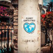 planet earth first poster on a concrete post