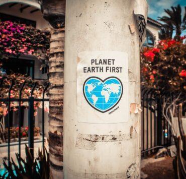 planet earth first poster on a concrete post