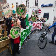 officer standing beside bike and people with signs