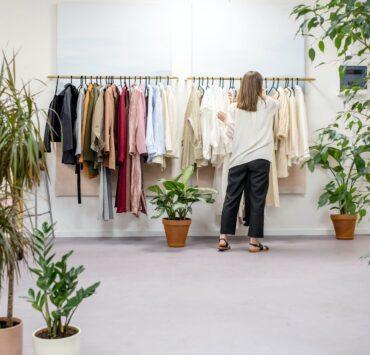 woman fixing clothes on the rack