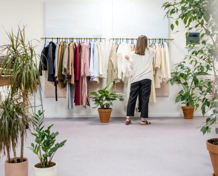 woman fixing clothes on the rack