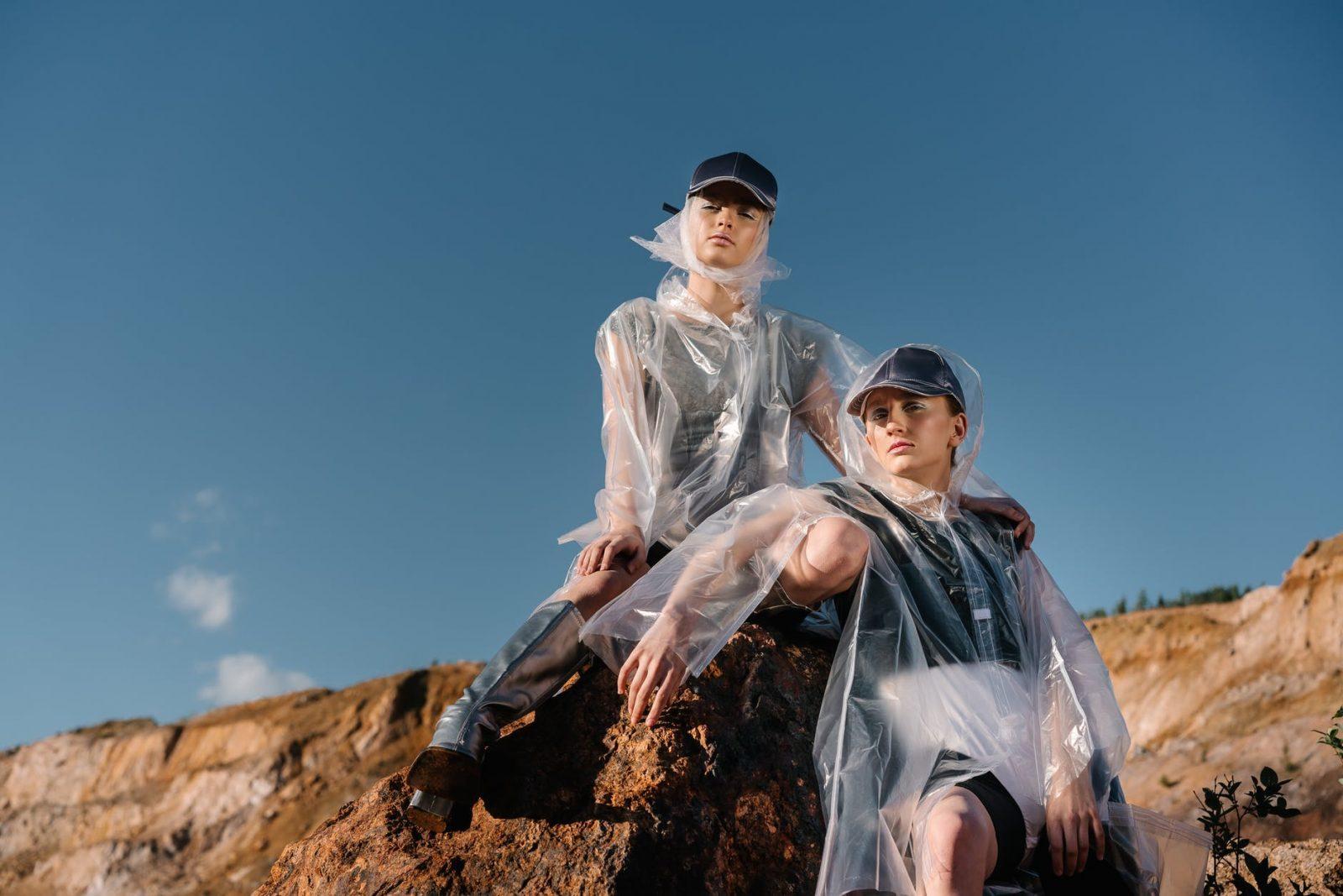 women wearing caps and transparent raincoats