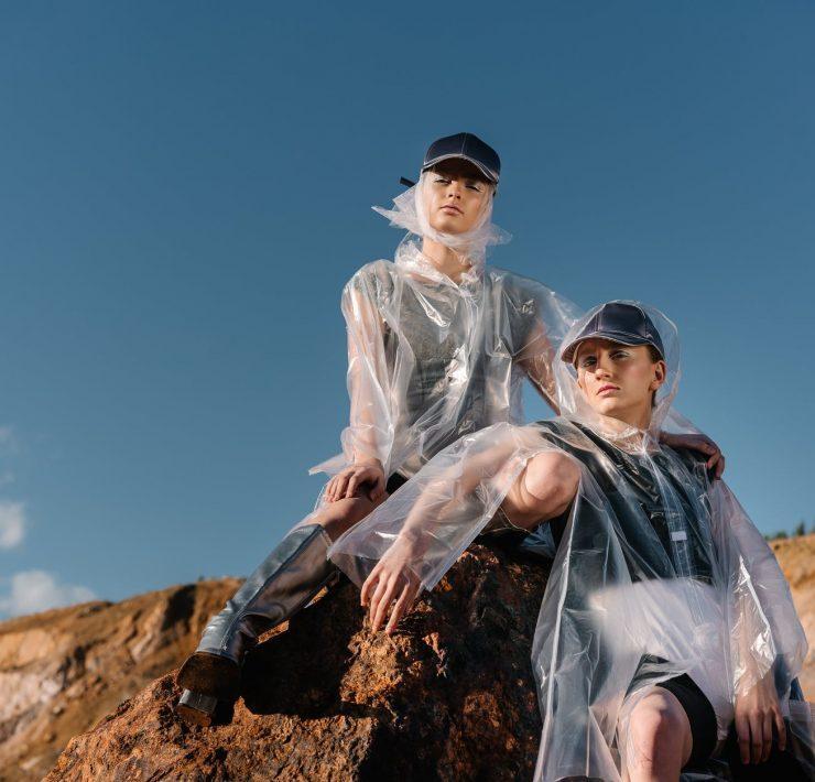 women wearing caps and transparent raincoats