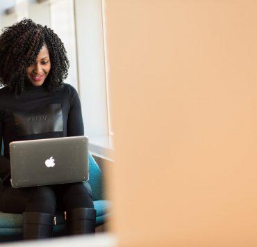 woman holding macbook