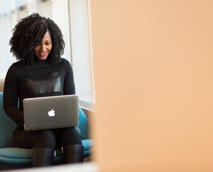 woman holding macbook