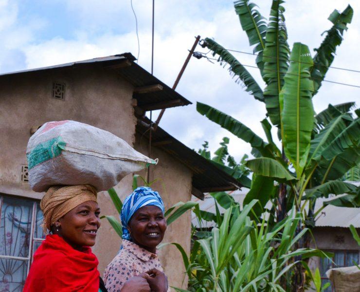 two girls walking near the concrete house