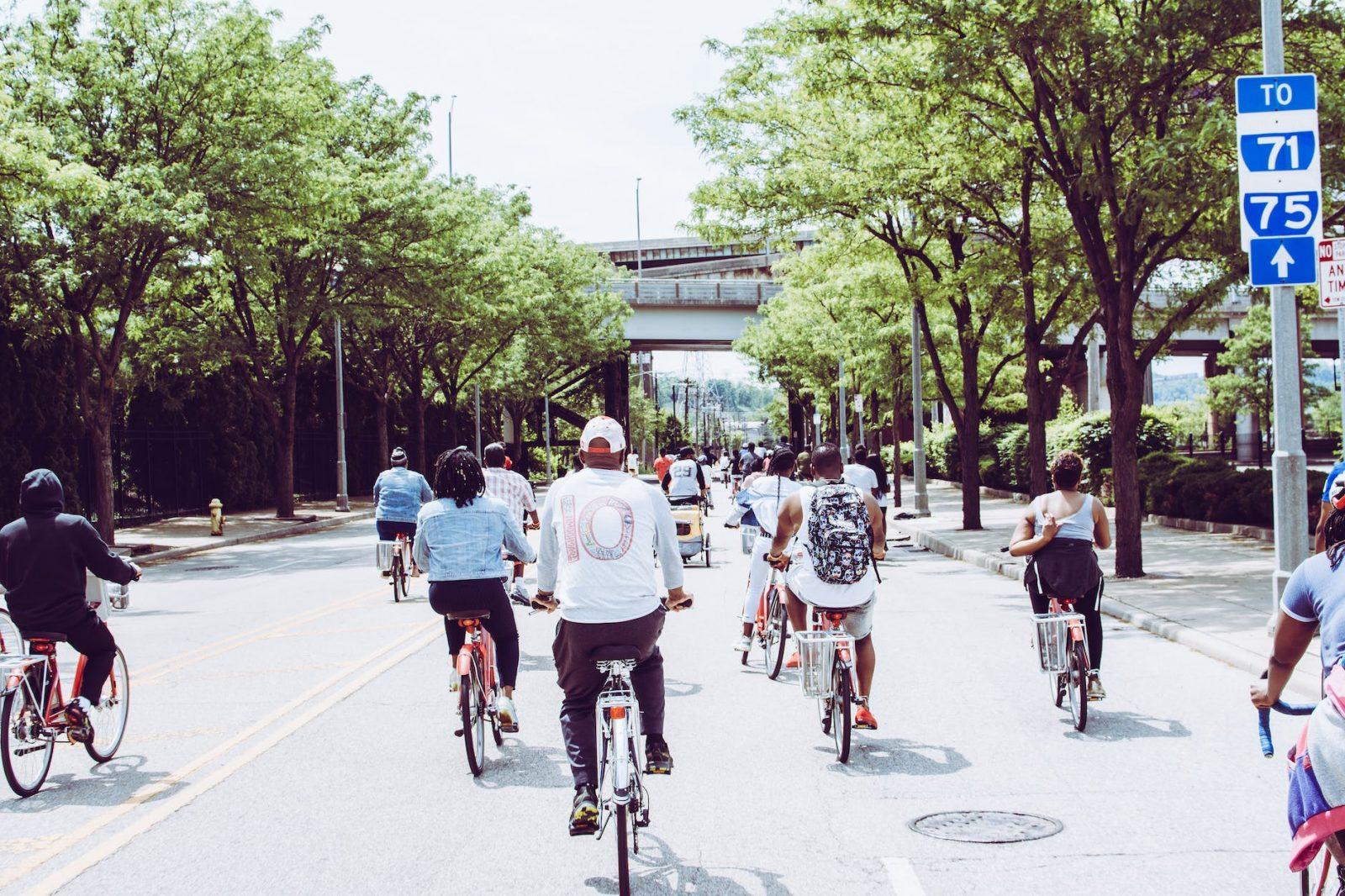 people riding bicycle on concrete road