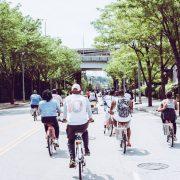 people riding bicycle on concrete road
