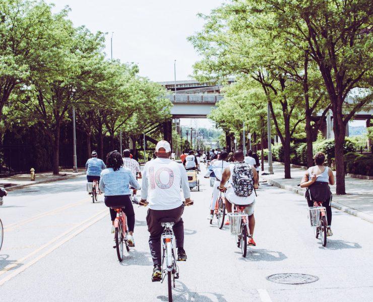 people riding bicycle on concrete road