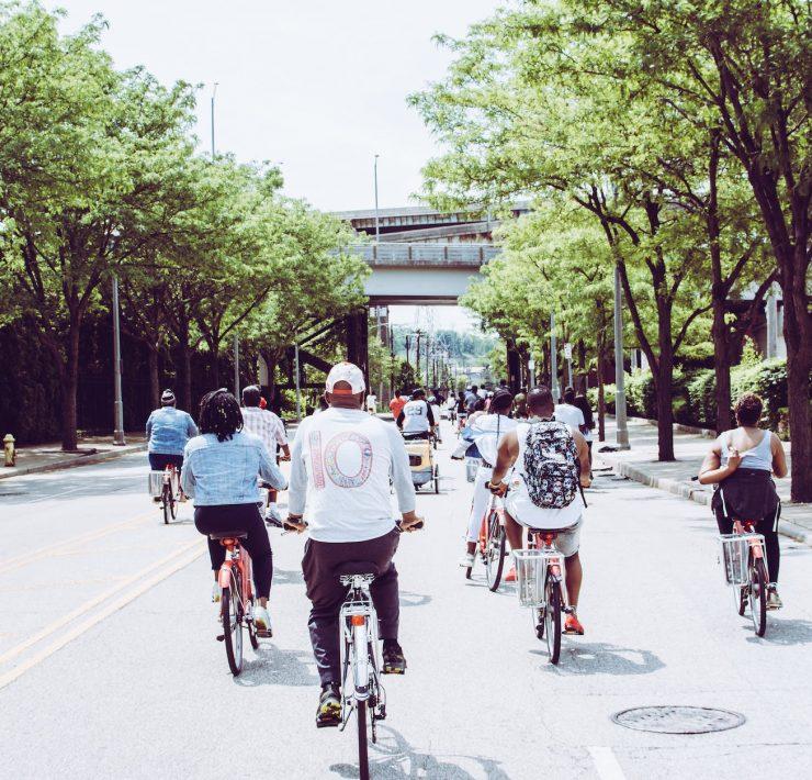 people riding bicycle on concrete road