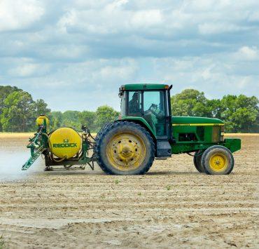 green and yellow tractor on dirt
