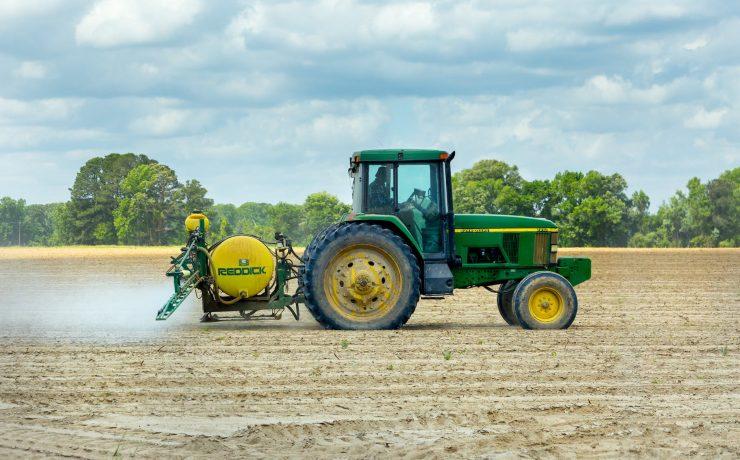 green and yellow tractor on dirt