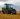 green tractor plowing the fields on focus photography