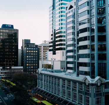 buses on road near high rise buildings
