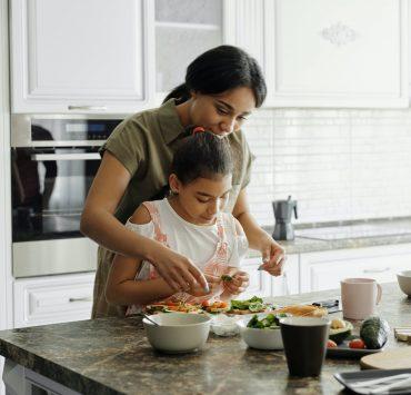 mother and daughter preparing avocado toast