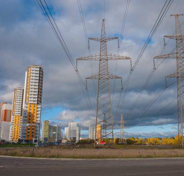 electrical posts and power lines under cloudy sky