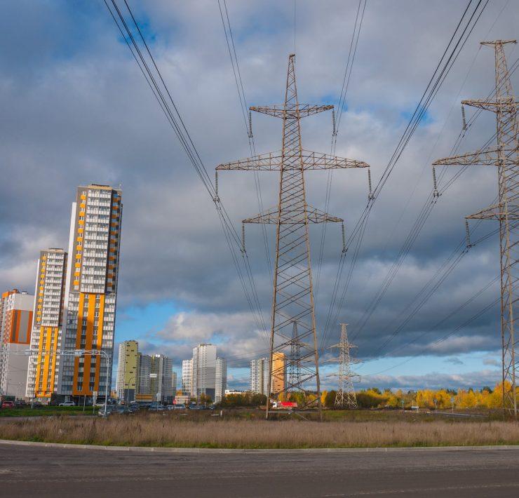 electrical posts and power lines under cloudy sky