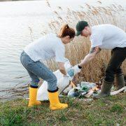 a man and a woman picking up garbage