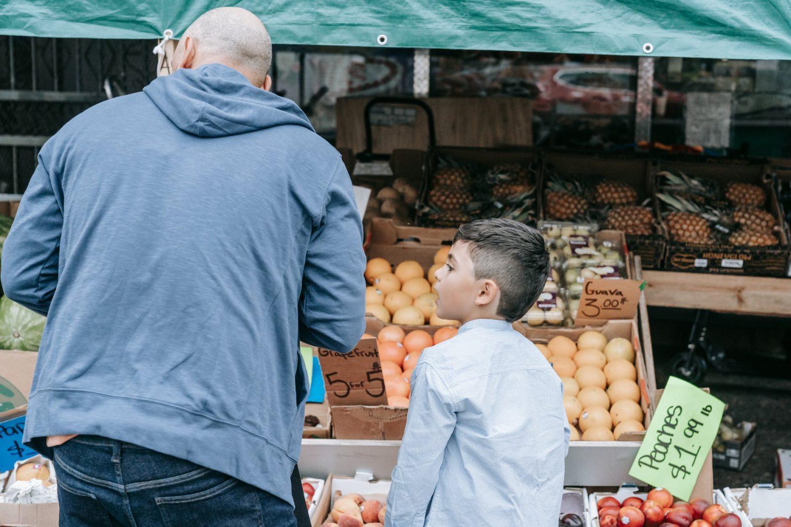 father and son shopping at the market