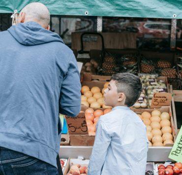 father and son shopping at the market
