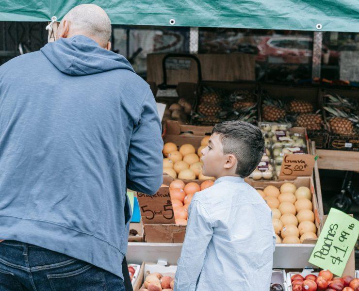 father and son shopping at the market