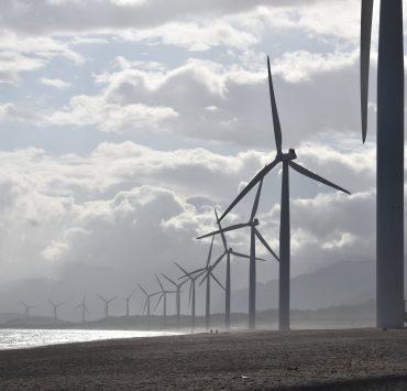 windmills on seashore under white clouds