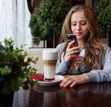 portrait of woman photographing with smart phone