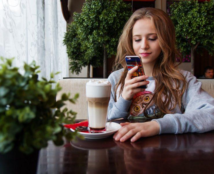portrait of woman photographing with smart phone