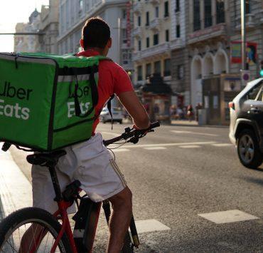 a delivery man riding a bike