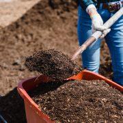 brown soil in orange plastic bucket