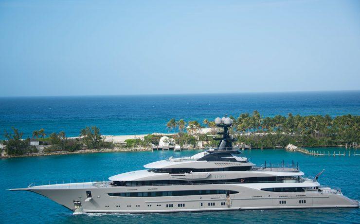 white and blue yacht on body of water