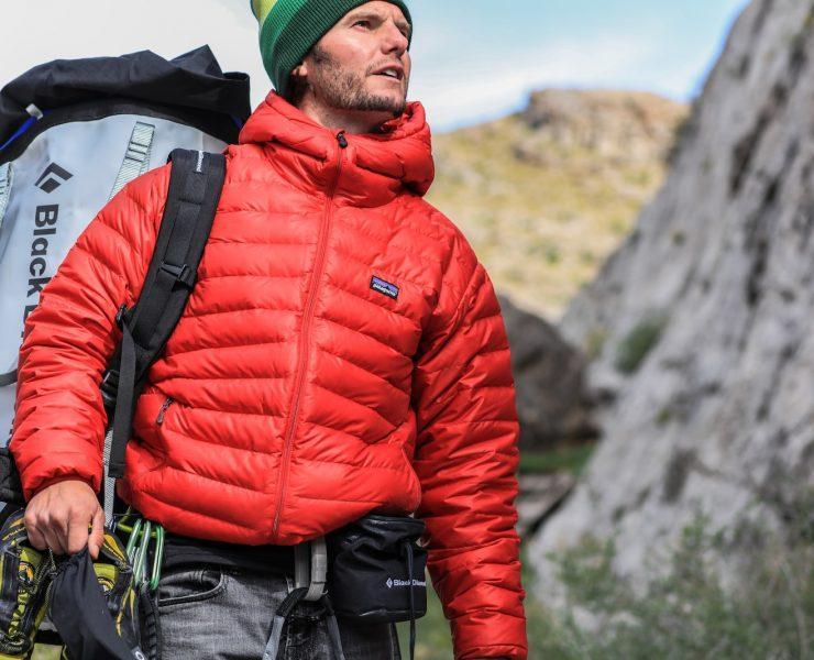 man looking above carrying gray camping backpack