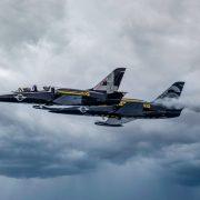 black fighter jet flying in the sky