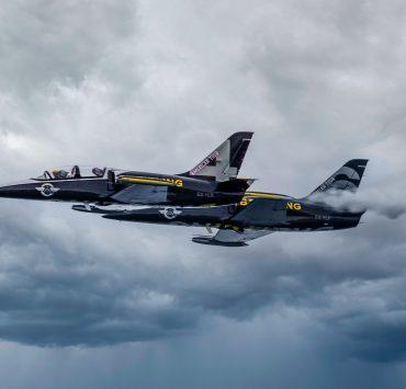 black fighter jet flying in the sky