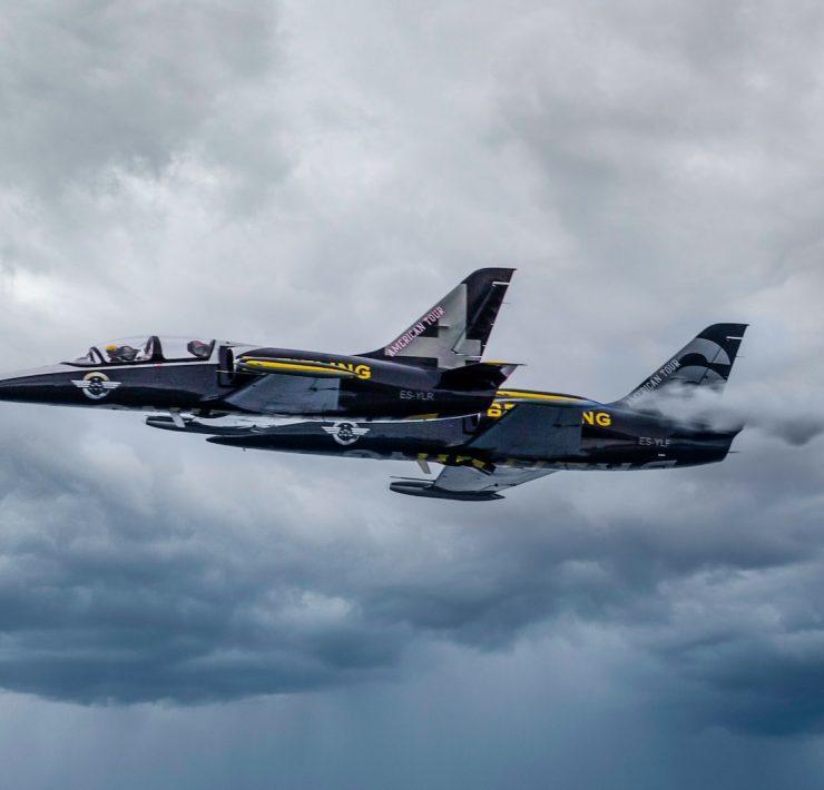 black fighter jet flying in the sky