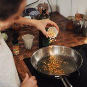 person holding stainless steel round tray with food