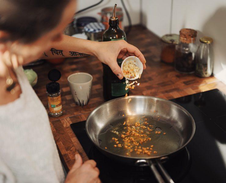 person holding stainless steel round tray with food