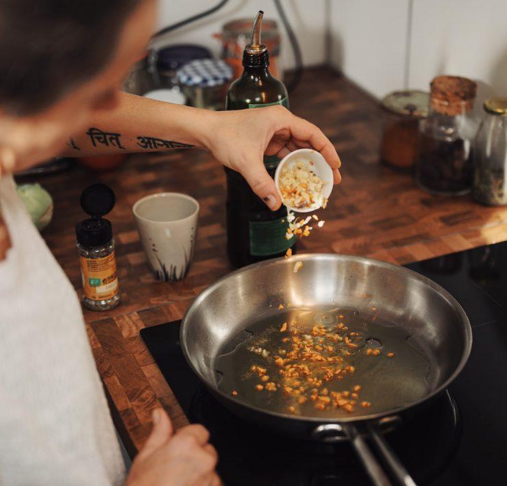 person holding stainless steel round tray with food