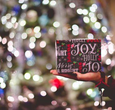 selective focus photography of gift box on person's palm