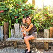 woman in black tank top sitting on brown wooden bench