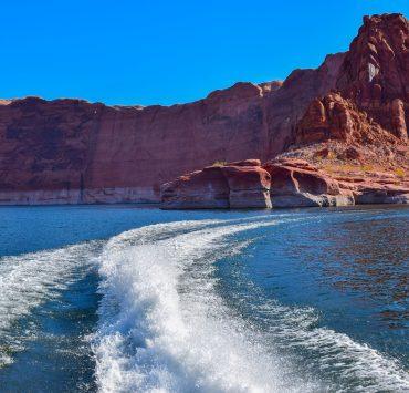 brown rocky mountain beside blue sea during daytime
