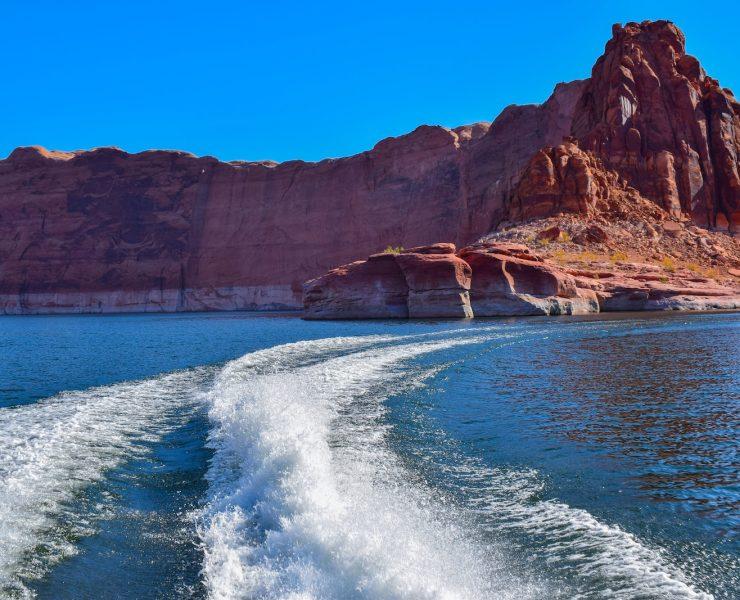 brown rocky mountain beside blue sea during daytime