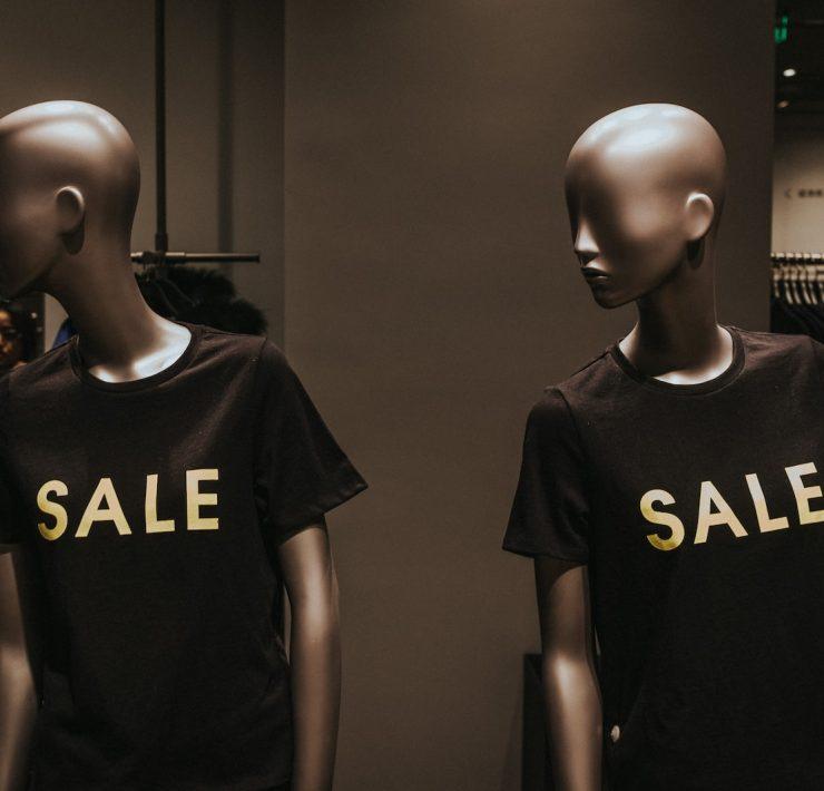 two mannequins with black Sale graphic crew-neck t-shirts
