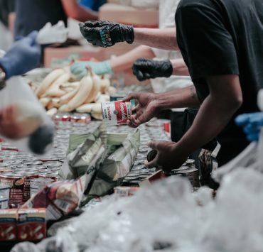 man in black t-shirt holding coca cola bottle