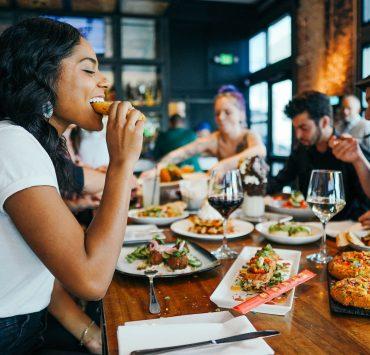 woman in white shirt eating