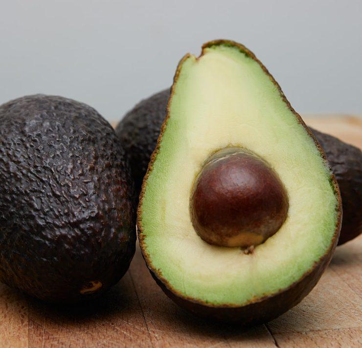 sliced avocado fruit on brown wooden table