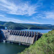 gray concrete dam under blue sky during daytime