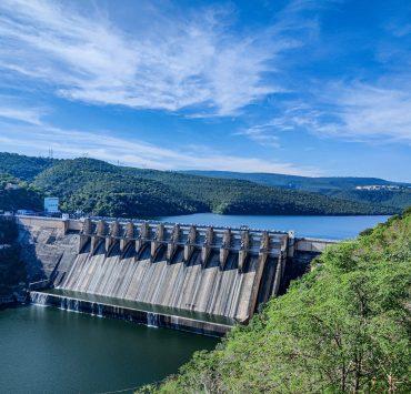 gray concrete dam under blue sky during daytime
