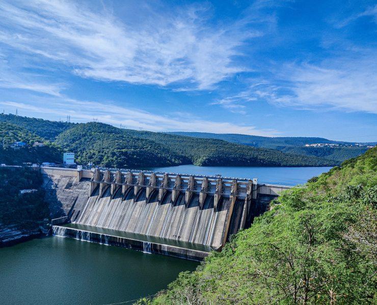 gray concrete dam under blue sky during daytime