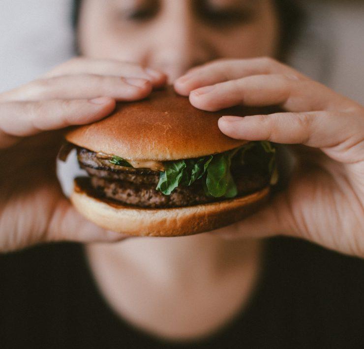 person holding burger